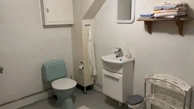 a small bathroom with a toilet and a sink at Casa Hauge - Fjord View in Sandane