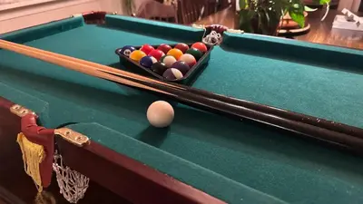 a pool table with a ball and cues on at Casa Hauge - Fjord View in Sandane