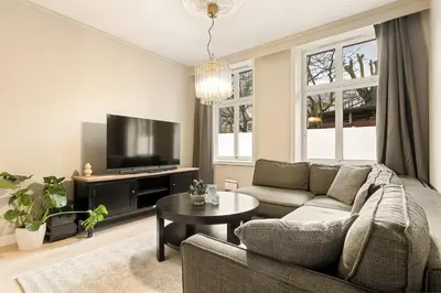 a living room with a couch and a tv at Modern Apartment in Bergen