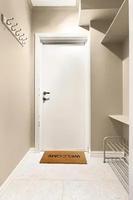a door with a welcome mat in front of it at Modern Apartment in Bergen