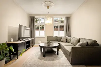 a living room with a couch and a table at Modern Apartment in Bergen
