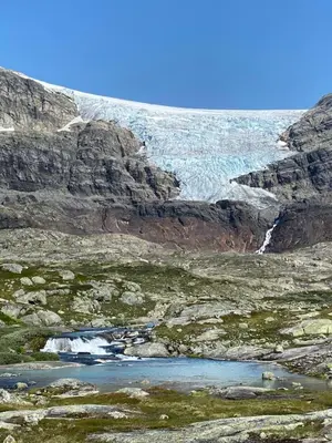a glacier on the side of a rocky mountain at Fjellperlen, Hardangervidda in Eidfjord