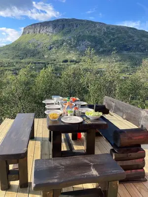 a picnic table with bowls of food on top of a mountain at Fjellperlen, Hardangervidda in Eidfjord