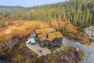 an aerial view of a house with a grass roof at NEW cozy and large lodge with private Jacuzzi and sauna in Eggedal