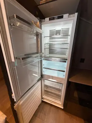 an empty refrigerator with its door open in a kitchen at NEW cozy and large lodge with private Jacuzzi and sauna in Eggedal