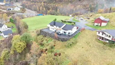 an aerial view of a large house on a field at Utsikten in Masfjorden