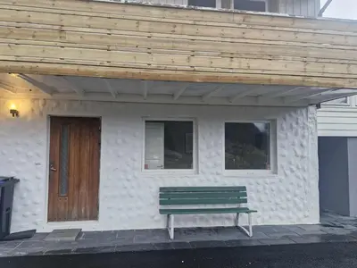 a house with a bench in front of it at Utsikten in Masfjorden