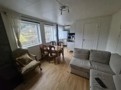 a living room with a couch and a table at Utsikten in Masfjorden