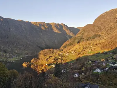 a view of a valley with a river and mountains at Utsikten in Masfjorden