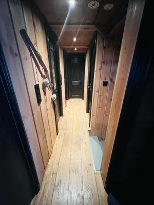 a hallway in a house with wooden walls at Cabin in Kvamskogen in Kvam