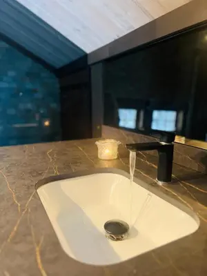 a sink in a bathroom with water coming out of it at Cabin in Kvamskogen in Kvam