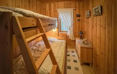 a small room with a bunk bed and a window at Amazing Apartment In Braskereidfoss With Wifi in Braskereidfoss