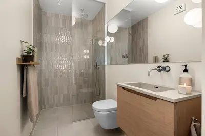 a bathroom with a toilet and a shower and a sink at Unik villaeiendom, totalrenovert i klassisk stil in Trondheim