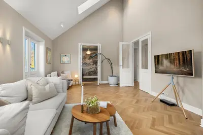 a living room with a white couch and a table at Unik villaeiendom, totalrenovert i klassisk stil in Trondheim