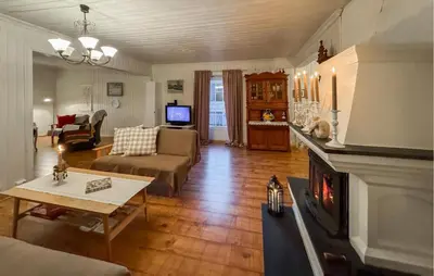 a living room with a couch and a fireplace at Nice Home In Braskereidfoss With Wifi in Braskereidfoss
