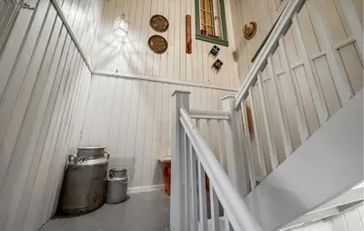 a hallway with a staircase with a trash can and a barrel at Nice Home In Braskereidfoss With Wifi in Braskereidfoss