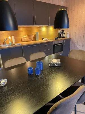 a kitchen with a table with blue cups on it at Ski-in & ski-out apartment in Hafjell in Øyer