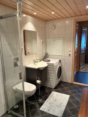 a bathroom with a toilet and a sink and a shower at Ski-in & ski-out apartment in Hafjell in Øyer