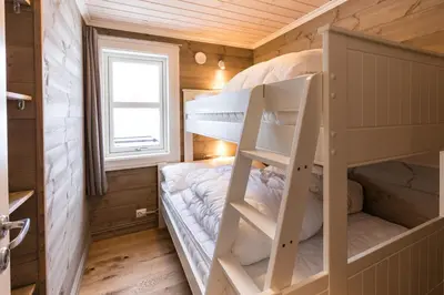 a bedroom with bunk beds in a tiny house at Stranda Fjellgrend 3 bedrooms - 98B in Stranda