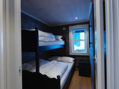 a bedroom with two bunk beds and a window at Stranda Fjellgrend 3 bedrooms - 98A in Stranda