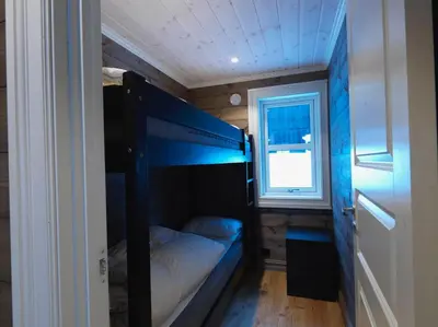 a small room with a bunk bed and a window at Stranda Fjellgrend 3 bedrooms - 98A in Stranda