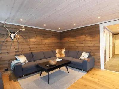 a living room with a couch and a table at Stranda Fjellgrend 3 bedrooms - 98A in Stranda
