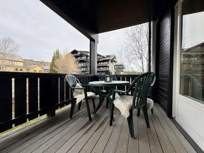 a patio with a table and chairs on a balcony at Central apartment - walking distance to everything in Holo