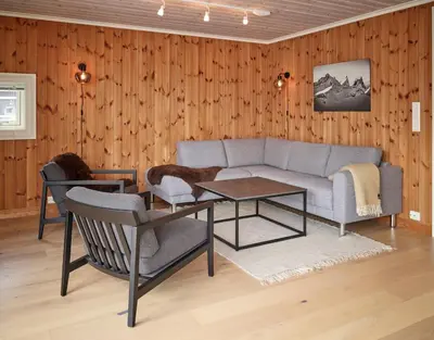 a living room with a couch and a table at Stranda Fjellgrend 2 bedrooms - 76B in Stranda