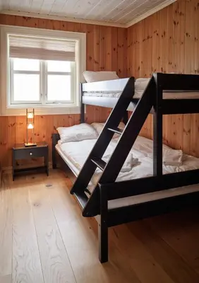 two bunk beds in a room with a window at Stranda Fjellgrend 2 bedrooms - 76B in Stranda