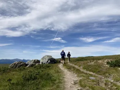 a man and woman walking down a dirt trail at Apartment in Gol Skisenter in Gol