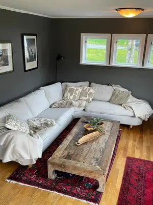 a living room with a white couch and a wooden coffee table at Spacious and luxurious house with stunning views in Vossevangen