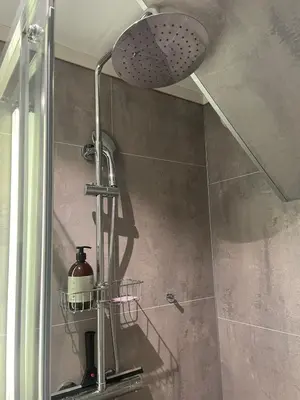 a shower with a shower head in a bathroom at Spacious and luxurious house with stunning views in Vossevangen