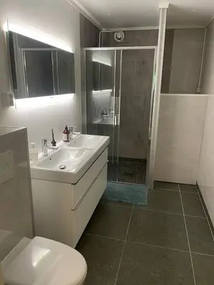 a bathroom with a toilet and a sink and a shower at Spacious and luxurious house with stunning views in Vossevangen