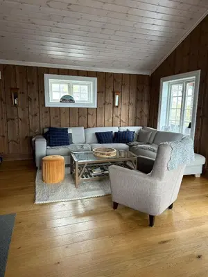 a living room with a couch and a table at Rustik hytte i Gausta, ski in, ski out, 10 beds in Gaustablikk