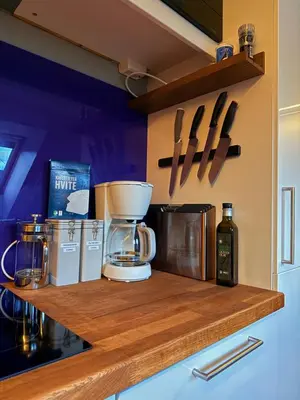 a kitchen counter with a coffee maker on a counter top at Cozy Apartment Next to Solsiden in Trondheim