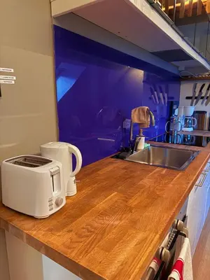 a kitchen counter with a toaster and a sink at Cozy Apartment Next to Solsiden in Trondheim