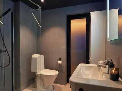 a bathroom with a white toilet and a sink at Cozy Apartment Next to Solsiden in Trondheim
