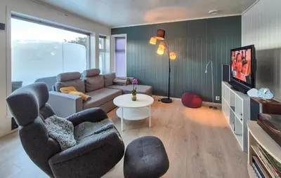 a living room with a couch and a table at Awesome Apartment In Finnås With House Sea View in Vinnes