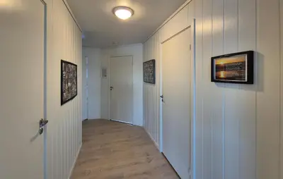 a hallway with white walls and a hallway with two doors at Awesome Apartment In Finnås With House Sea View in Vinnes