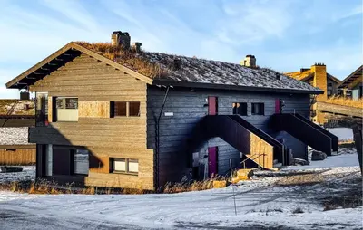 an old building in the snow next to a bridge at Amazing Apartment In Øyer With Wifi in Øyer