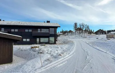 a snow covered road in front of a house at Amazing Apartment In Øyer With Wifi in Øyer
