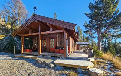a small cabin in the woods with a porch at Stunning Home In Austbygda With Wifi in Austbygdi