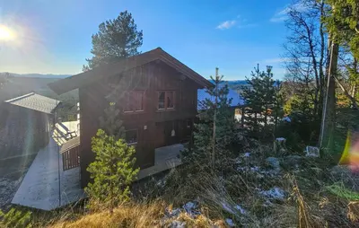 a small wooden cabin with a rainbow in the sky at Stunning Home In Austbygda With Wifi in Austbygdi