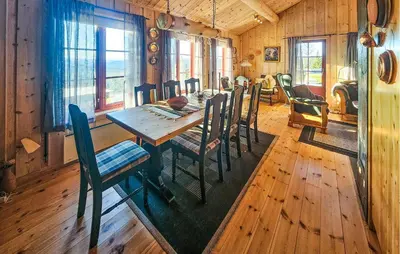 a dining room with a wooden table and chairs at Stunning Home In Austbygda With Wifi in Austbygdi