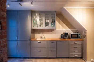a kitchen with blue cabinets and a sink at Sentralen in Trysil