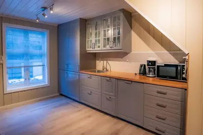 a kitchen with a sink and a microwave at Sentralen in Trysil