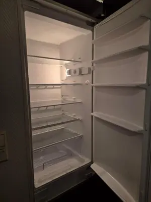 an empty refrigerator with its door open in a room at Cozy 2BD apartment in Central Bergen in Bergen