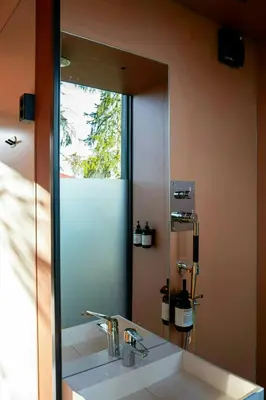 a bathroom mirror with a sink in front of it at Modern Cabin By The Cross-Country Trails in Svene