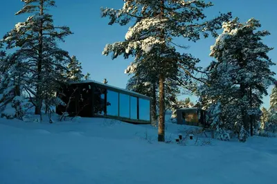 a glass house in the snow with trees at Modern Cabin By The Cross-Country Trails in Svene