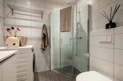 a bathroom with a glass shower and a toilet at Midtbyen Apartment in Trondheim